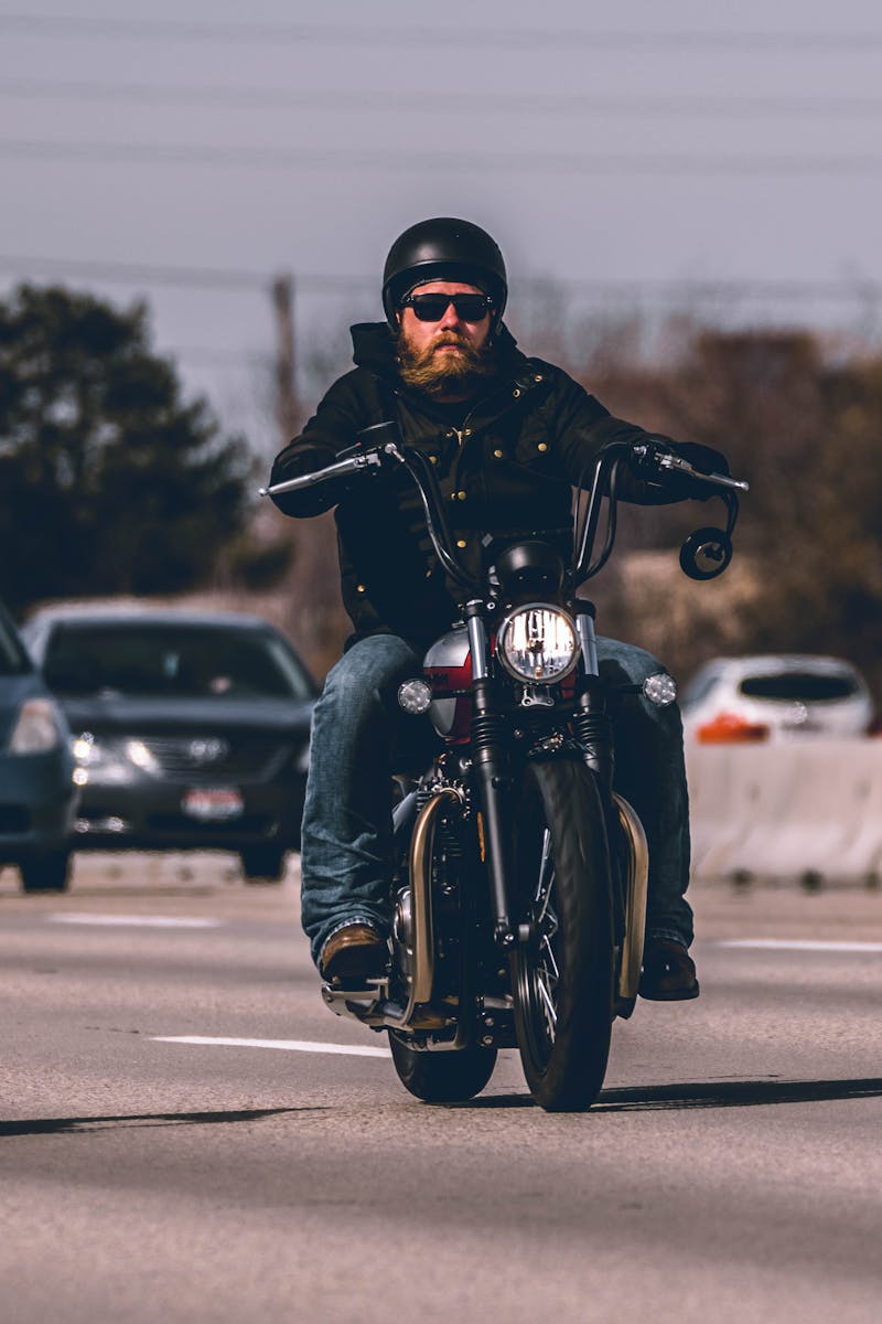 Man Riding Motorcycle on Highway