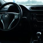 the interior of a car with a steering wheel and dashboard