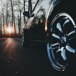 black car in the middle of the road during nightfall