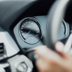 person holding steering wheel